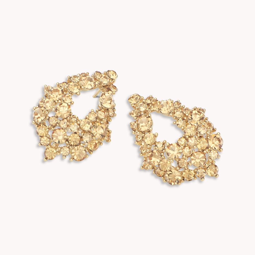 Our Alice earrings, feature multi-faceted rich yellow tinted Swarovski crystals that reflect the light beautifully. Set in gold, wear them to add understated elegance to everyday looks. Match with Miranda bracelet and ring.