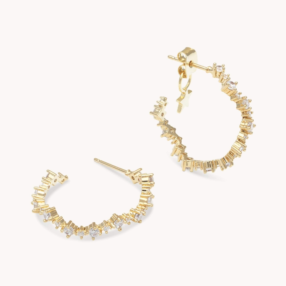 New to the collection the Capella hoop earring is the perfect addition to any look. Set in gold, these earrings bring loads of attention with curved lines that are completely adorned with endless petite clear Swarovski cubics.